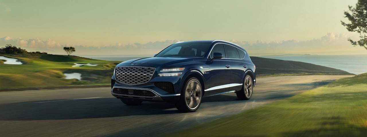 Front view comparing the 2025 Genesis GV80 and the 2025 Volvo XC90, emphasizing luxury design elements and potential 2025 Genesis GV80 configurations.