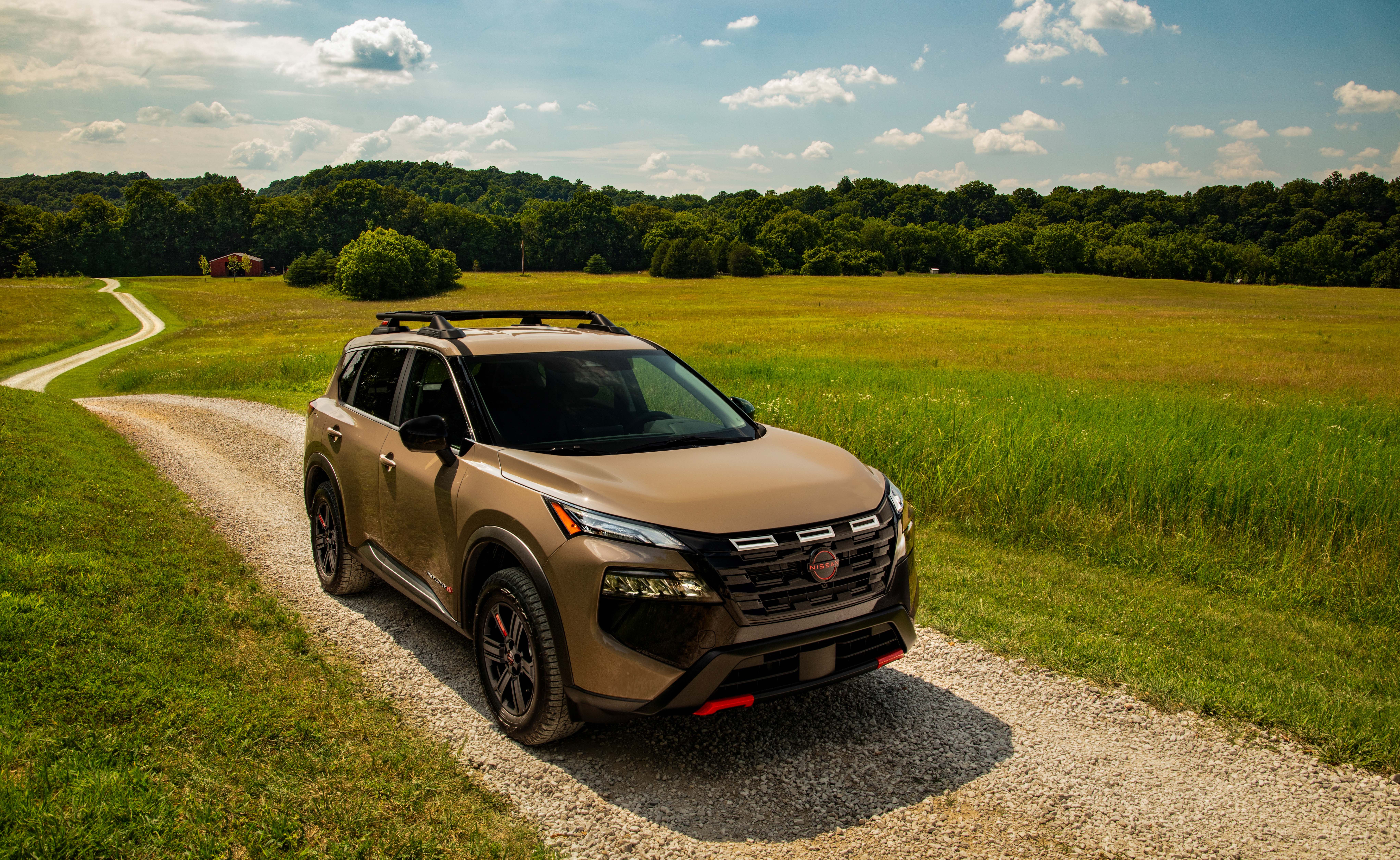 2025 Nissan Rogue SUV parked in a scenic outdoor setting, highlighting spacious and versatile design.