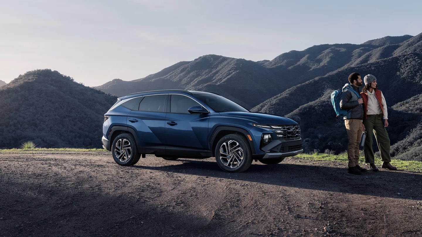 2025 Hyundai Tucson blue SUV mountain background, Hyundai Tucson adventure SUV Fort Worth, best SUV for Texas weekend hiking trips, Tucson lifestyle photo DFW Hyundai, couples SUV for camping trips, Hyundai Tucson for outdoorsy drivers, new Hyundai crossover Fort Worth, Tucson with AWD off-road capability