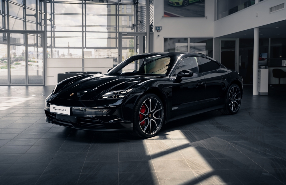 2025 Porsche Taycan GTS black exterior, luxury EV in Porsche Fort Myers showroom, Taycan for sale in Fort Myers, new Porsche Taycan inventory Southwest Florida, Porsche electric sports car Florida dealership, Taycan lease specials Fort Myers