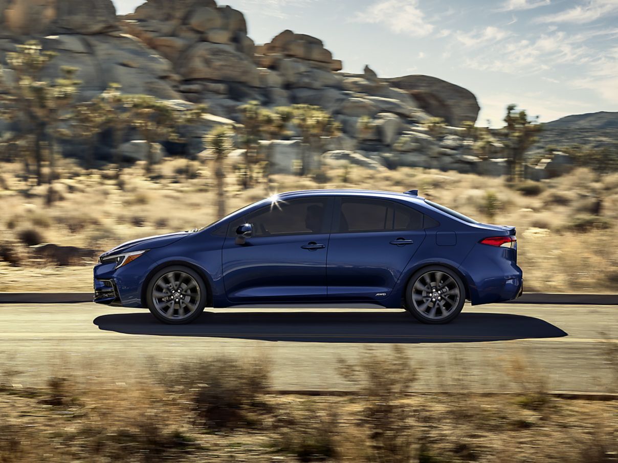 Toyota hybrid sedan driving Tennessee road near Knoxville, Prius Corolla Camry Hybrid fuel-efficient highway driving, hybrid battery life tips Knoxville TN, Toyota Knoxville hybrid maintenance, summer heat battery cooling, Smoky Mountains road trip Toyota hybrid, Toyota dealer service Knoxville