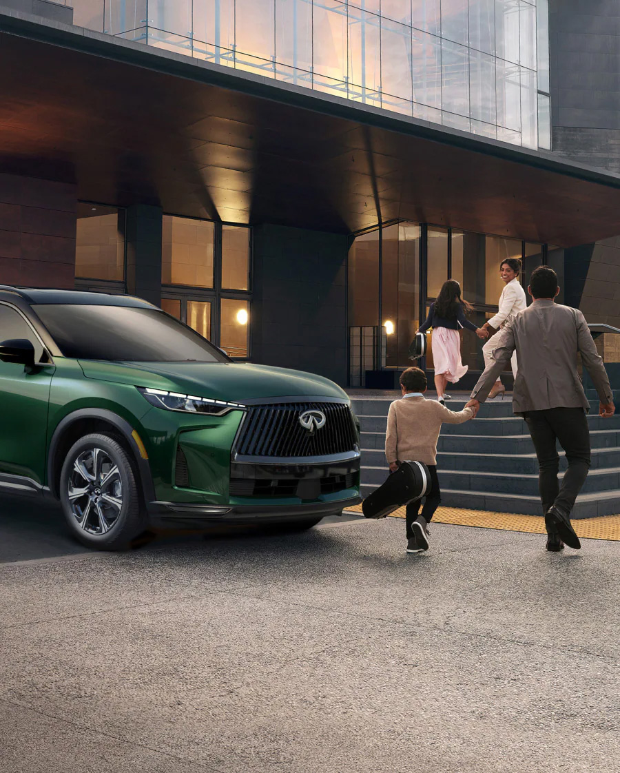 2026 INFINITI QX60 exterior in green, family walking in Orlando