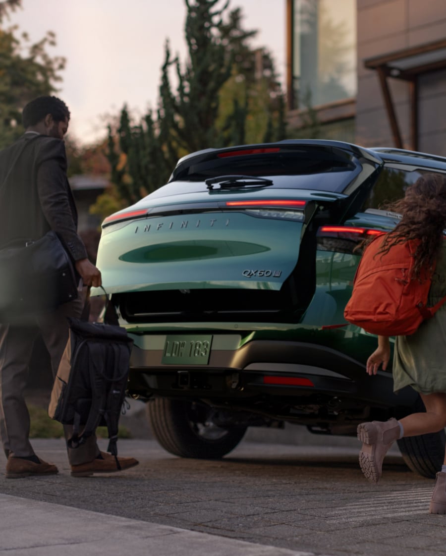2026 INFINITI QX60 rear liftgate open, family loading bags for an Orlando road trip