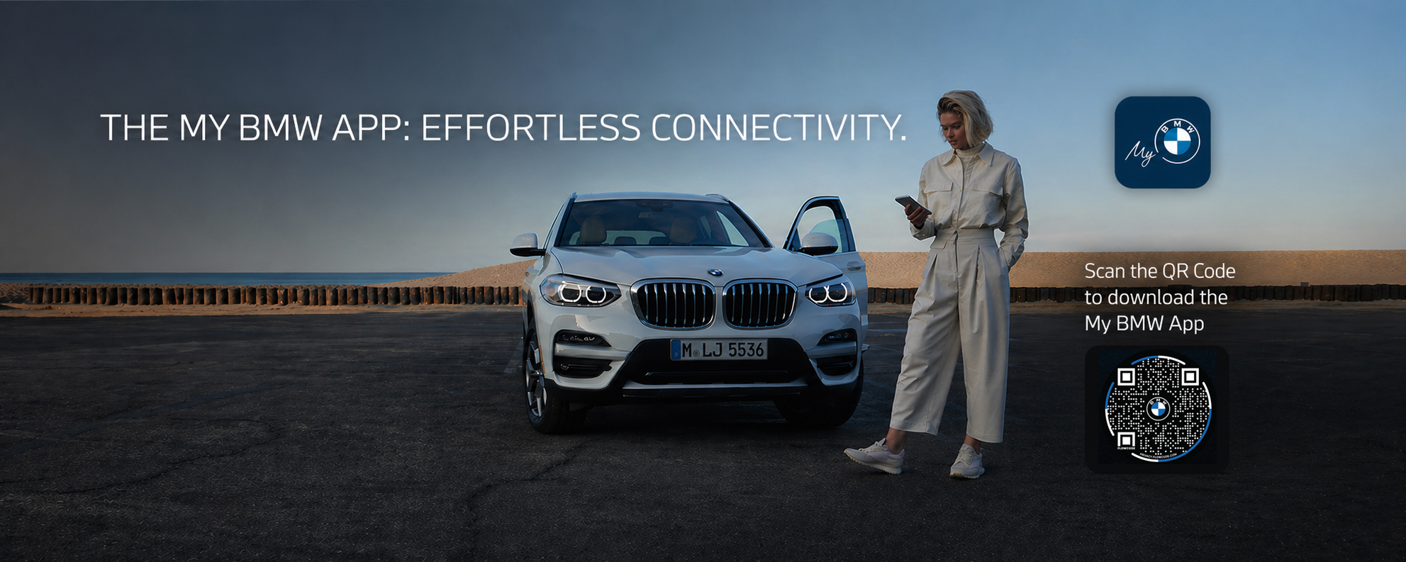 My BMW App displayed on a smartphone next to a BMW vehicle at BMW of Freeport in Freeport, New York