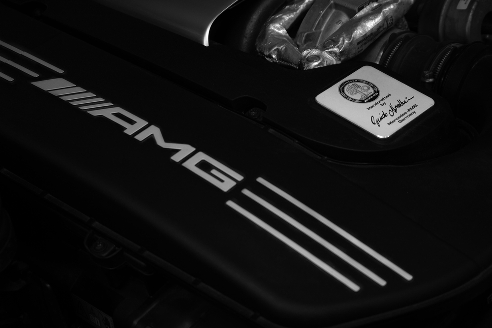 AMG engine close-up, hand-built Mercedes-AMG engine Affalterbach Germany, Mercedes-AMG 2000 mile break-in service Westminster CO, AMG badge, high-performance engine components, Mercedes-Benz Westminster AMG technician service, precision AMG engine maintenance Denver area