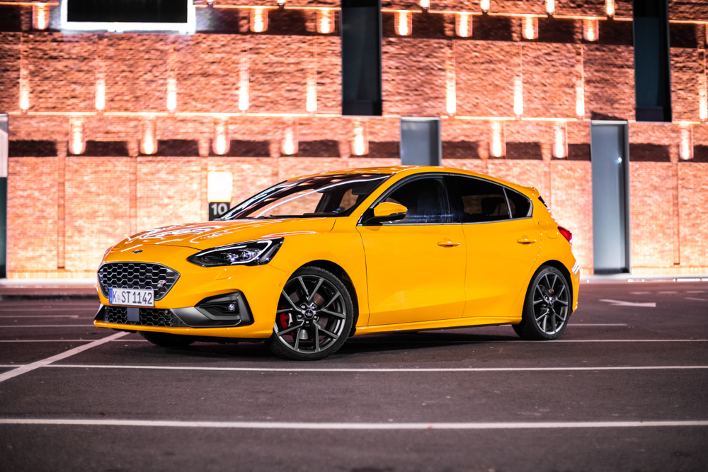 last generation Ford Focus ST hatchback, discontinued Ford Focus compact car, Ford Focus 2018 model year, sporty yellow Ford Focus night photo, Ford Focus for sale history, compact sedan alternative Haverhill MA, Ford sedan phase-out, why Ford stopped making Focus