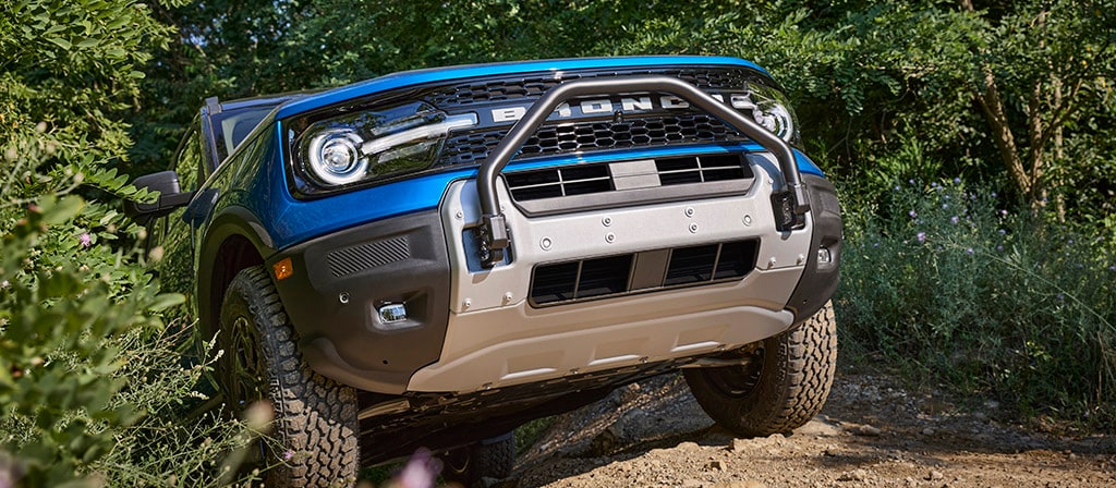 2025 Ford Bronco Sport Badlands model off-roading, front grille view Bronco Sport 4x4 New Hampshire, Manchester NH compact SUV trail ready, Bronco Sport G.O.A.T. Modes rock crawl feature, off-road SUV Ford dealership, Bronco Sport underbody armor Badlands trim