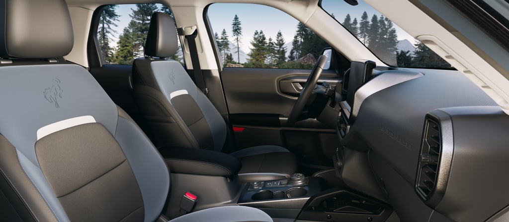 2025 Ford Bronco Sport interior view, Bronco Sport dashboard with touchscreen, front seating Badlands edition, G.O.A.T. Mode dial interior, Manchester NH Ford SUV tech, Bronco Sport Sync 4 touchscreen, adventure SUV cabin New Hampshire, Bronco Sport removable floor mats and cargo features