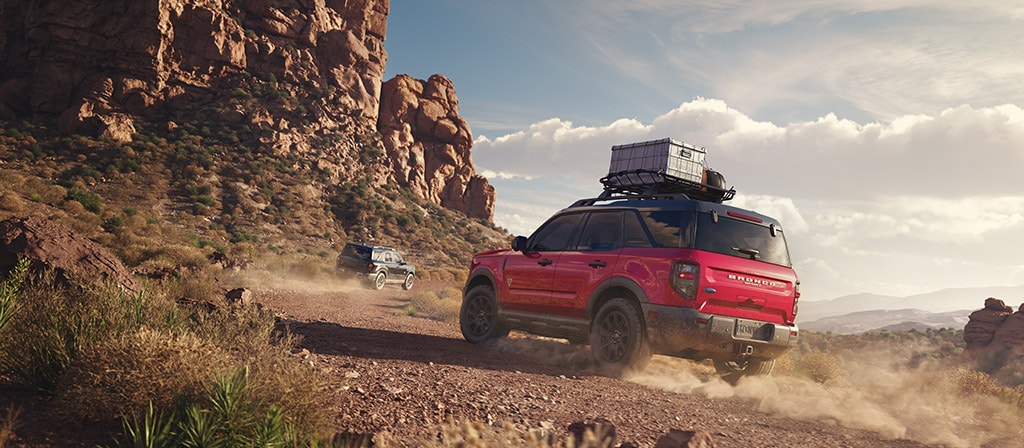 2025 Ford Bronco Sport adventure SUV in red, Bronco Sport roof rack gear, canyon trail SUV driving, Ford Bronco Sport compact 4x4 off-road, Manchester NH Bronco Sport trail use, Ford SUV for weekend camping, G.O.A.T. Modes Bronco Sport terrain drive