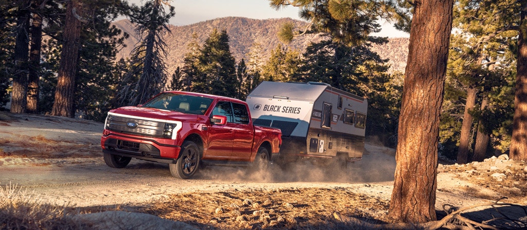 2025 Ford F-150 Lightning towing trailer in New Hampshire, electric truck towing capacity, F-150 Lightning adventure ready, Ford Lightning truck hauling camper, Ford electric truck trail performance, Lightning EV truck range towing, F-150 Lightning for New England drivers