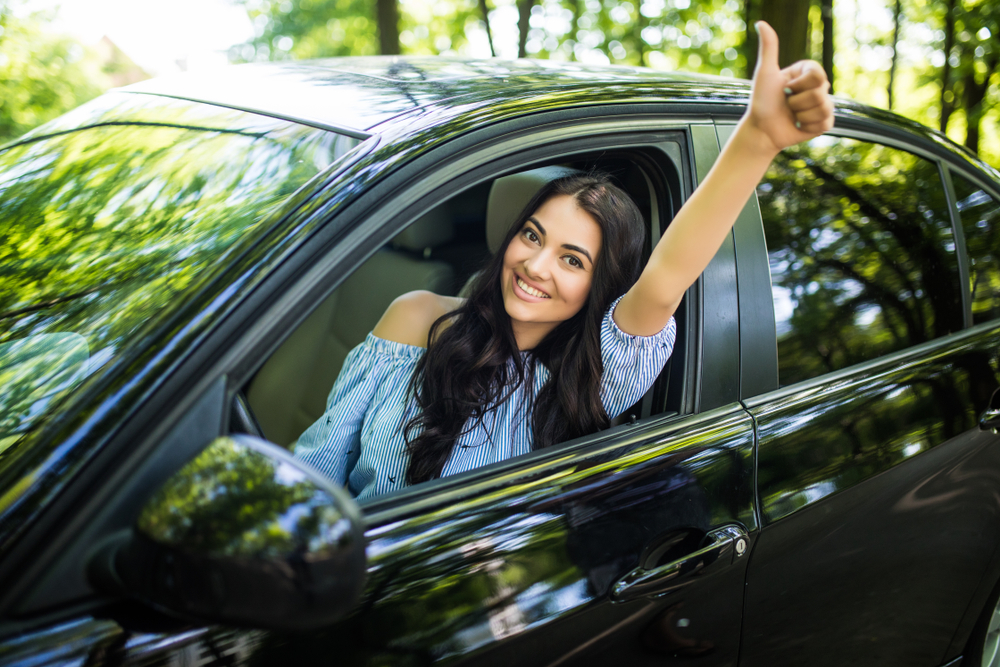 Young woman driving car after bad credit auto loan approval in Manchester NH, credit rebuilding car loan AutoFair, easy car financing for low credit score, no credit or bankruptcy car loans New Hampshire