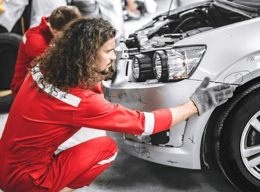 BMW collision repair technician inspecting front bumper, BMW of Freeport Collision Center body shop, certified BMW collision repair Long Island, BMW bumper refinishing before lease return, Freeport NY BMW service technicians, BMW lease-end repair estimate, factory-trained BMW body technician Nassau County, BMW OEM parts and paint matching for lease inspection, BMW lease return preparation services