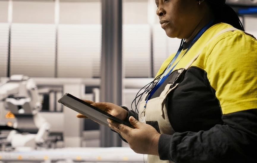 collision center technician in uniform holding tablet in modern repair facility, advanced diagnostic equipment in background, BMW ADAS calibration specialist, radar and camera alignment after deer collision, BMW Laserlight and sensor programming, certified BMW of Freeport Collision Center technician, Long Island factory-approved diagnostic tools, Nassau County BMW safety system recalibration