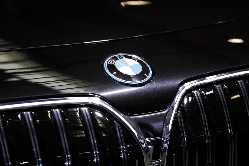 BMW hood gloss restoration Freeport NY, showroom quality paint BMW Nassau County, luxury car detailing Long Island, professional BMW paint repair Freeport, BMW Freeport Collision paint finish, BMW badge with flawless paint reflection