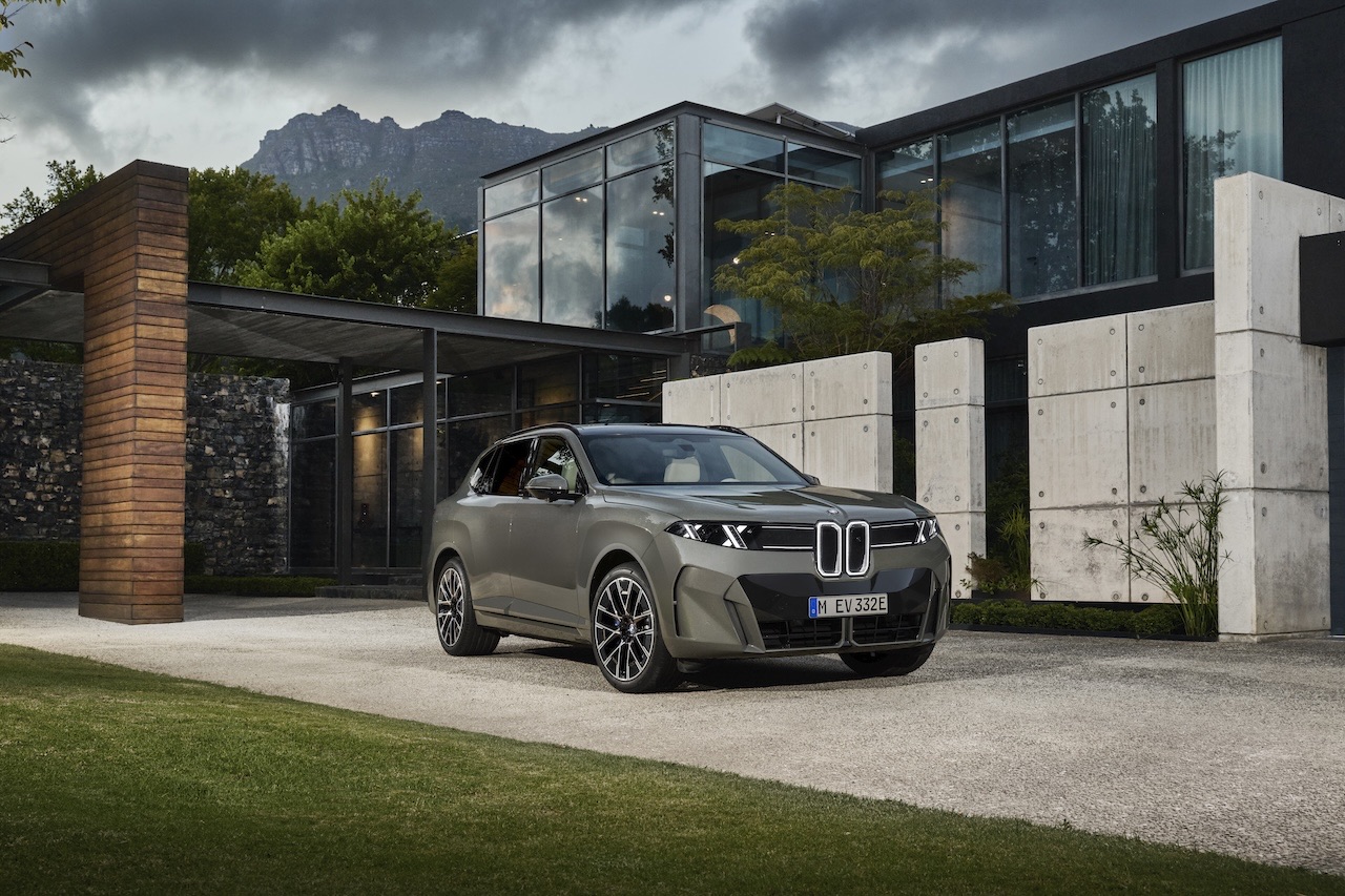 2027 BMW X5 parked in a modern driveway, showing the redesigned SAV's front-end styling