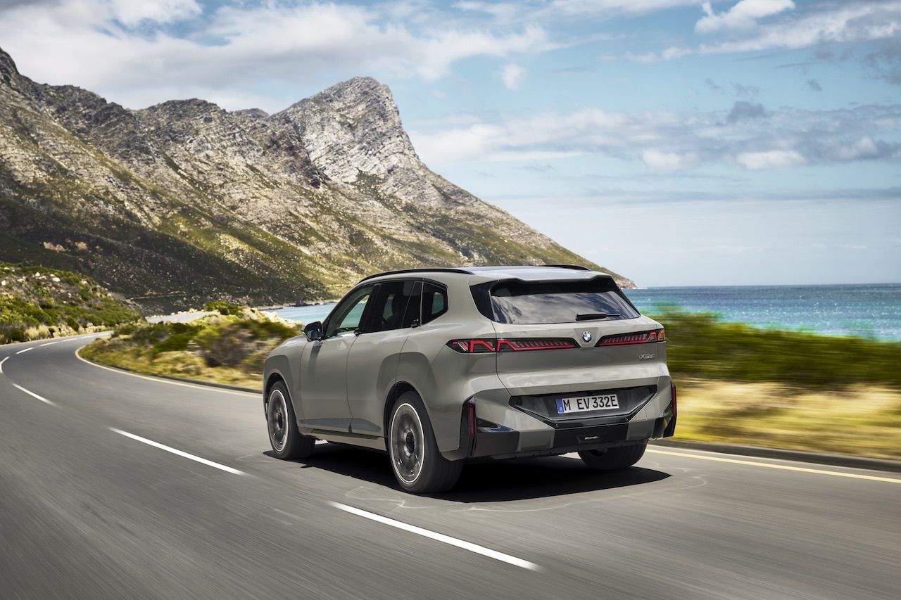 Rear view of the 2027 BMW X5 on a coastal road, showing the new liftgate