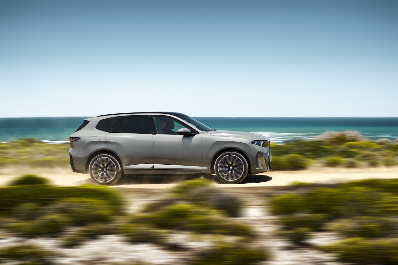 Side profile of the 2027 BMW X5 parked along the coast