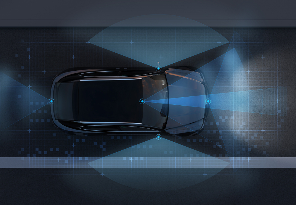 Top-down car graphic showing ADAS sensor coverage—camera and radar fields, Nissan ProPILOT Assist calibration, lane detection, adaptive cruise radar, Conyers GA Nissan service center, Rockdale County safety systems, advanced driver assistance