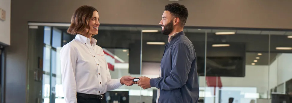 Conyers Nissan Service advisor with customer, schedule fall car maintenance Conyers GA, factory-trained Nissan technicians, genuine Nissan parts Rockdale County, service check-in near Highway 20, hassle-free appointment, Nissan service center customer experience Georgia