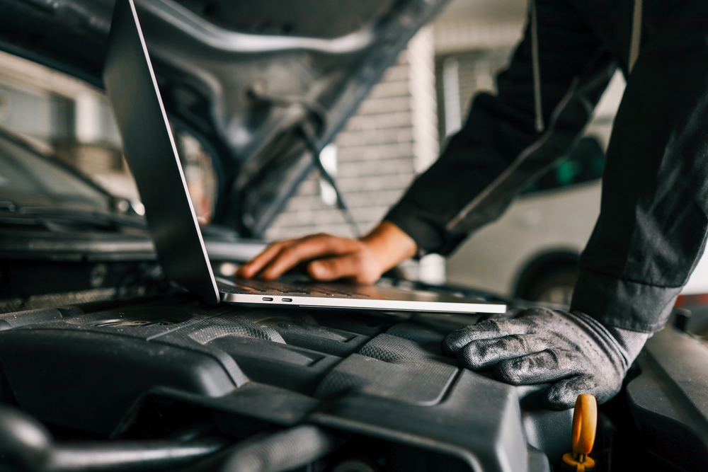 Certified technician using factory diagnostic laptop, Nissan ADAS calibration tools, ProPILOT Assist service Conyers GA, dealership equipment, sensor communication checks, Nissan service near I-20, Rockdale County calibration experts, diagnostic scan
