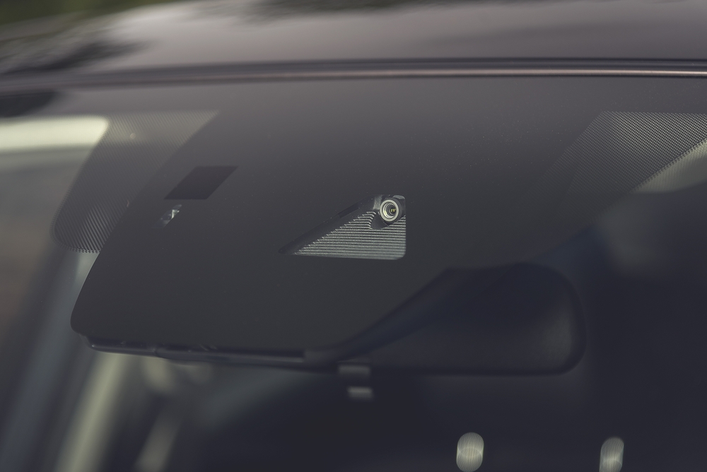 Forward-facing windshield camera close-up, Nissan lane camera, sensor alignment after windshield replacement, ADAS recalibration Conyers GA, ProPILOT Assist maintenance, Rockdale County Nissan dealership, camera obstructed warning fix