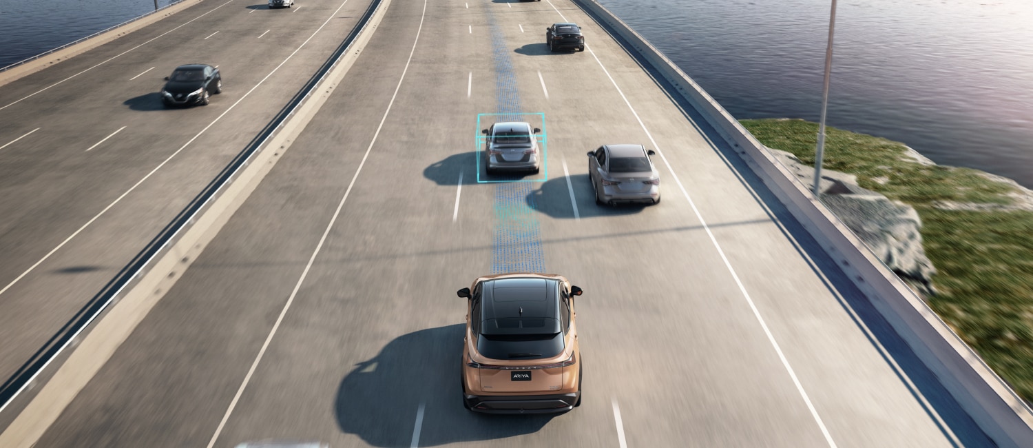 Nissan ProPILOT Assist maintaining following distance and lane centering, Ariya highway view, semi-autonomous driving, adaptive cruise, lane keep, ProPILOT warning light help, ADAS recalibration Conyers GA, Conyers Nissan Service near Rockdale County