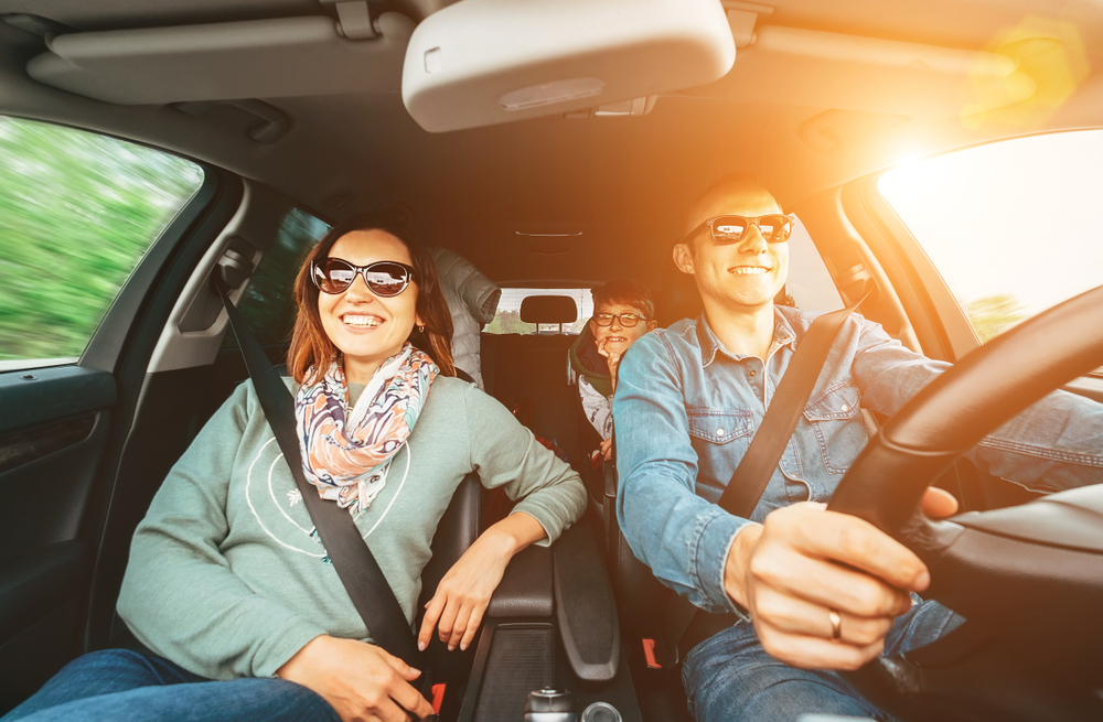 happy family riding in Ford with cold A/C, summer driving comfort, Ford air conditioning working perfectly, Palm Bay road trip, family in cool Ford SUV, air conditioned vehicle Florida heat