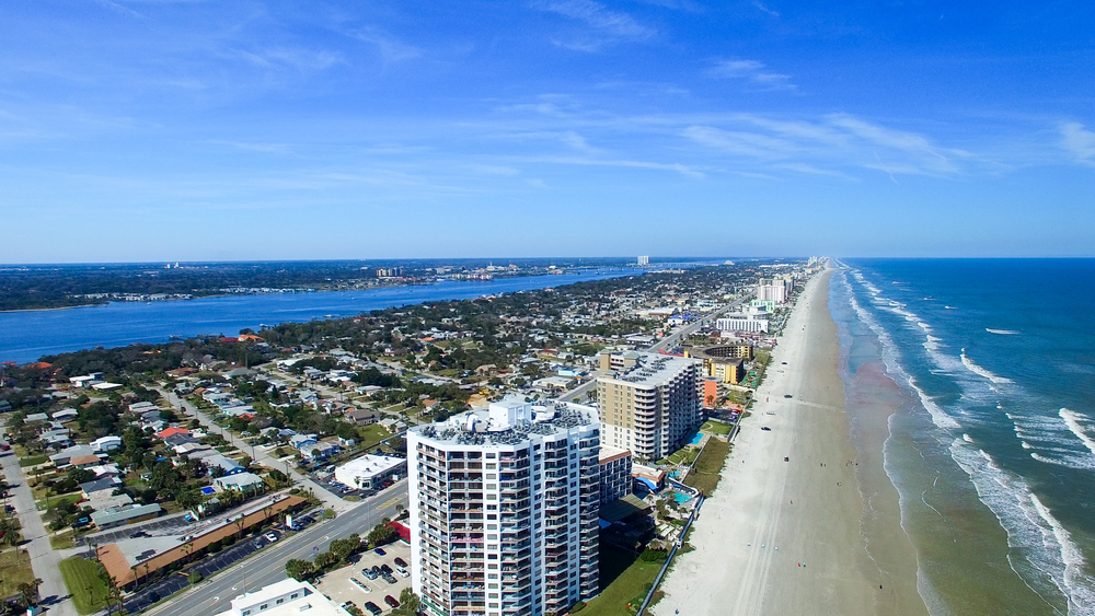 Daytona Beach Florida coastline aerial, A1A ocean road, salty coastal environment, hot humid climate, Mercedes-Benz of Daytona Beach service area, Florida heat impacts on AIRMATIC air suspension, schedule Mercedes inspection Daytona, GLS and GLE maintenance near Ormond Beach, luxury vehicle service Volusia County