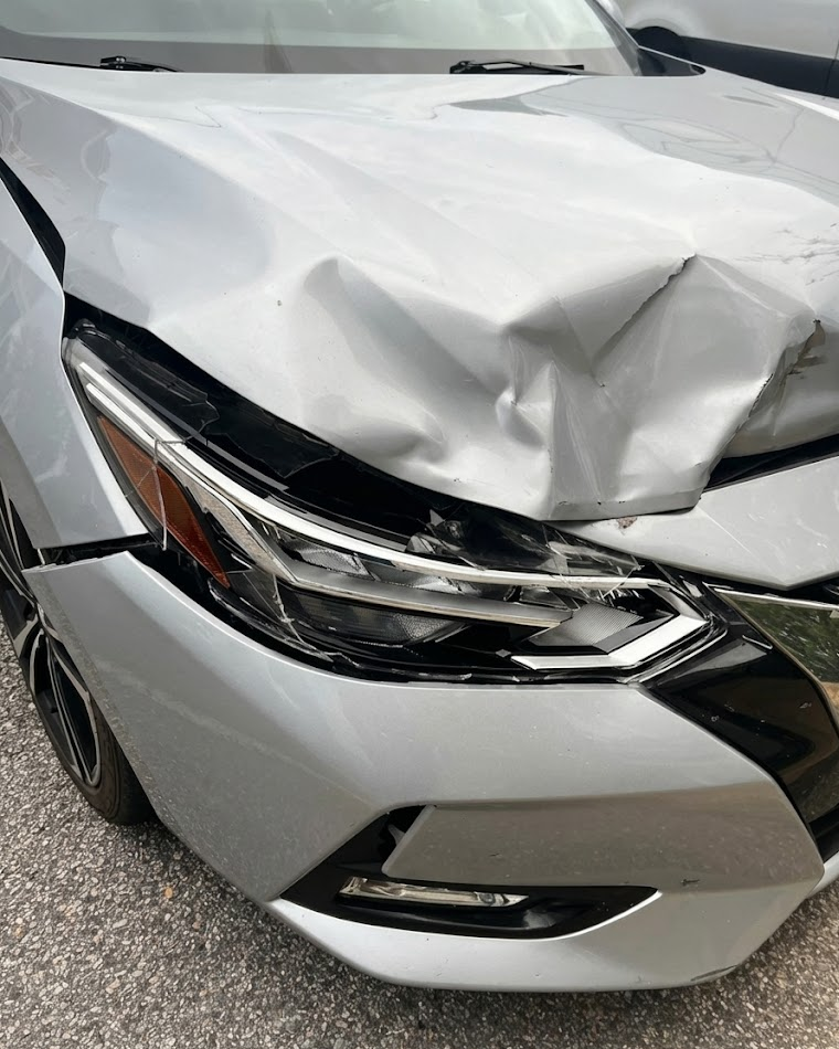 Silver sedan with crushed hood and front bumper damage, deer collision impact on Middle Tennessee road, hidden structural damage behind front end, cracked headlight and grille after wildlife crash, Cool Springs Collision Center deer-damage repair Franklin TN, front-end restoration for Nissan and Toyota sedans, OEM bumper and hood replacement, insurance-approved collision repair near Brentwood and Nashville