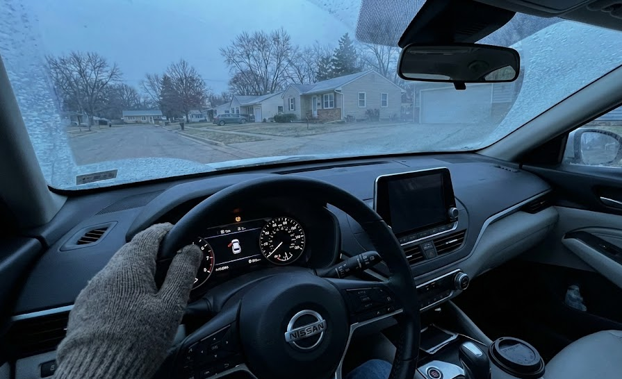 cold Charlotte NC morning inside Nissan, TPMS warning light on dashboard, East Charlotte Nissan Service tire pressure alert, Nissan TPMS horseshoe symbol with exclamation point, winter tire pressure problems in Charlotte, low tire pressure warning in Nissan Altima and Rogue, cold weather affecting tire PSI, Nissan dashboard closeup early morning commute, Nissan service near Independence Blvd Charlotte NC, understanding TPMS light in your Nissan, Charlotte driver worried about tire pressure, November and December cold snap tire issues