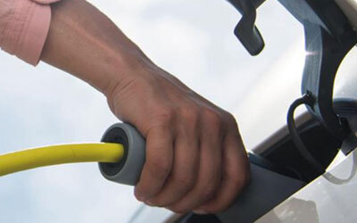 An EV charger plugged into a car.