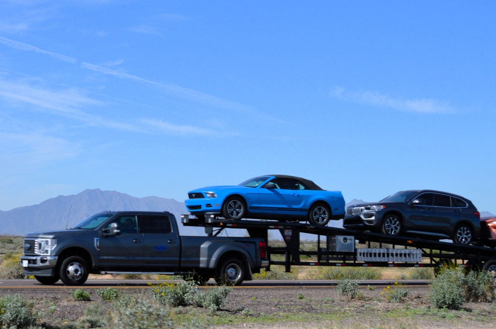 Ford F-350 hauling gooseneck car-hauler trailer, commercial towing Murfreesboro TN, heavy payload and trailer weight, Super Duty suspension performance under load, shocks struts control arm wear, truck stability and braking with cargo, professional hauler Rutherford County, towing near I-24 and I-840