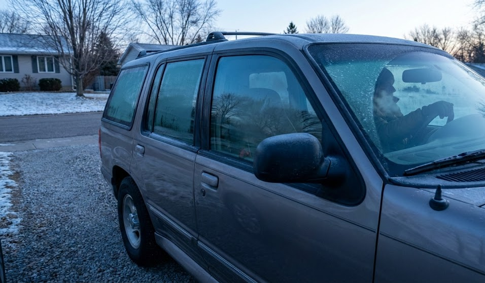 SUV covered in frost trying to start on cold Franklin Tennessee morning, visible breath from driver, first freeze exposing weak car battery, cold snap vehicle no-start problem, driveway scene common in Franklin and Nashville suburbs, need for complimentary battery test at Franklin CDJR, winter starting issues for Jeeps and Rams, Tennessee temperature drop effect on batteries, early morning commute stress, protect your battery before freezing weather hits