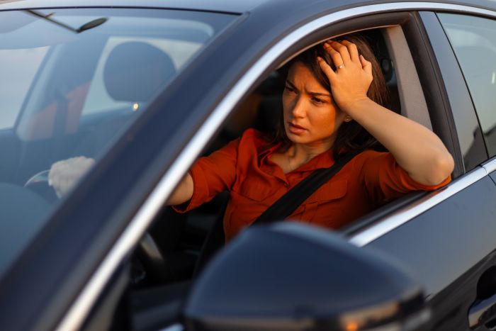Frustrated driver filing insurance claim after car accident in Athens GA, collision repair process, Athens auto body shop, insurance paperwork confusion, Georgia accident reporting laws