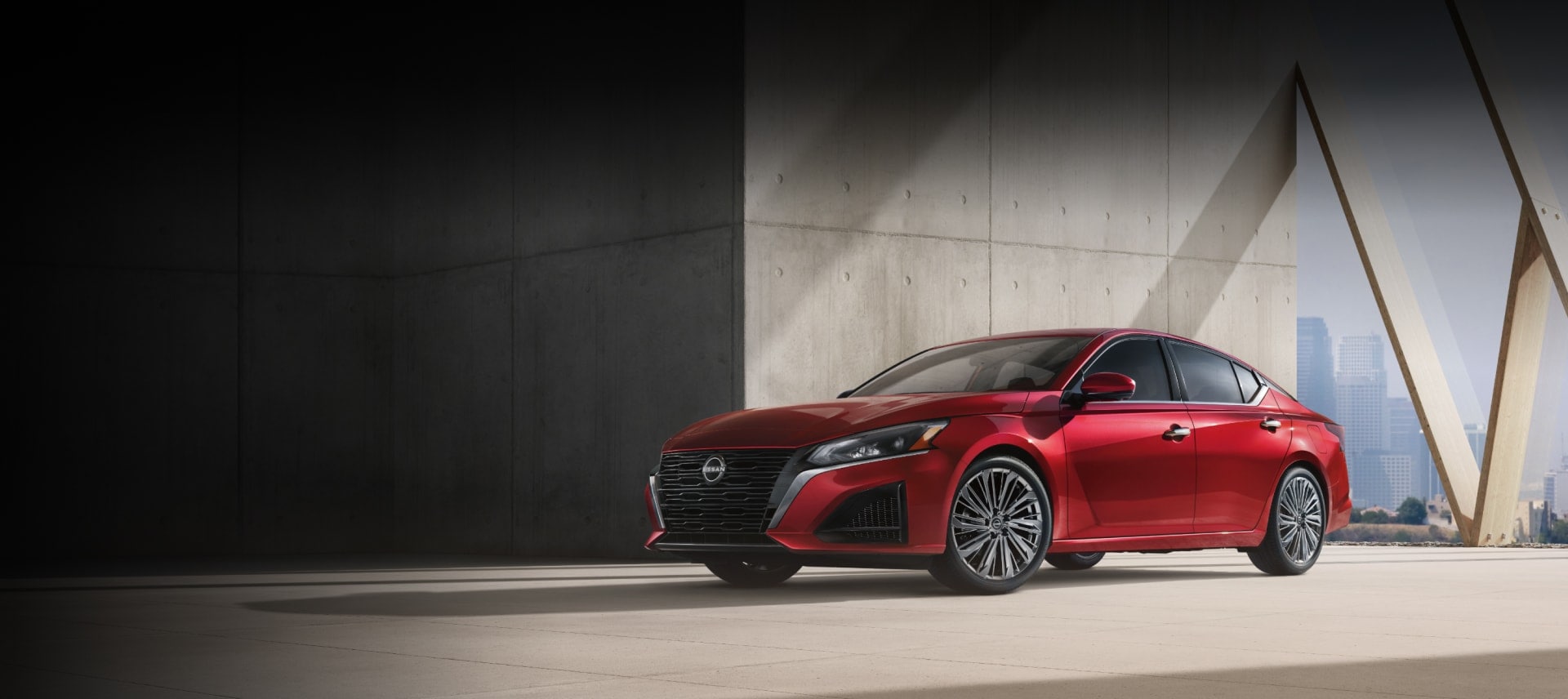 red Nissan Altima sedan parked in modern setting, Gainesville Nissan Altima for sale, Nissan sedan ready for Holiday highway travel, fuel-efficient Altima with TPMS and Easy-Fill Tire Alert, new Nissan models Gainesville FL, safe family sedan for I-75 road trips, visit Gainesville Nissan on North Main Street
