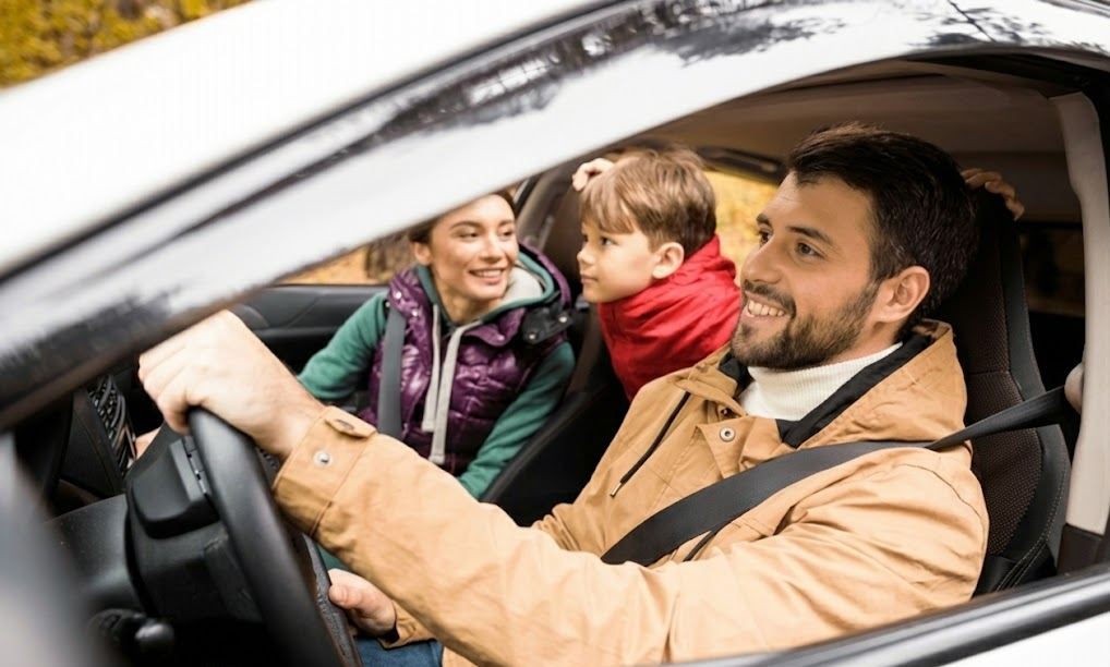 happy family driving Honda on fall road trip, smiling parents and child in safe Honda SUV, Louisville KY autumn foliage in background, confident driving after Honda tire inspection, Honda World Louisville tire replacement peace of mind, safe Honda Accord Civic CR-V family travel, fall and winter driving preparedness, Louisville Honda dealership service keeps families protected, comfortable quiet Honda cabin on leaf-covered roads