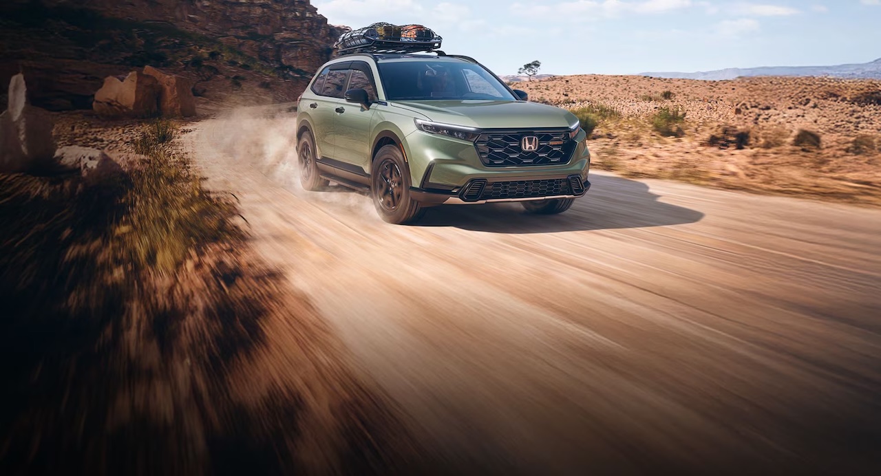 Green Honda CR-V on a trail, representing lease-end assistance from Honda of Denton in Denton, TX