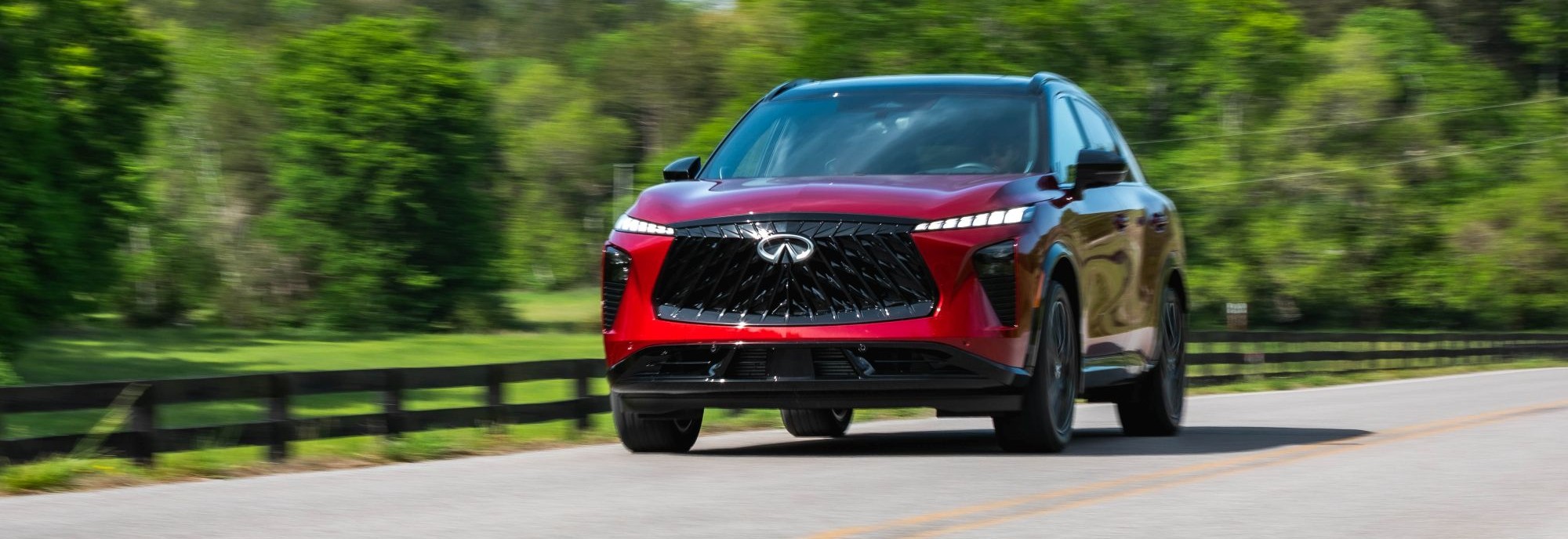 Red INFINITI SUV from the front three-quarter view for lease-return planning at Sawgrass INFINITI in Tamarac, FL.