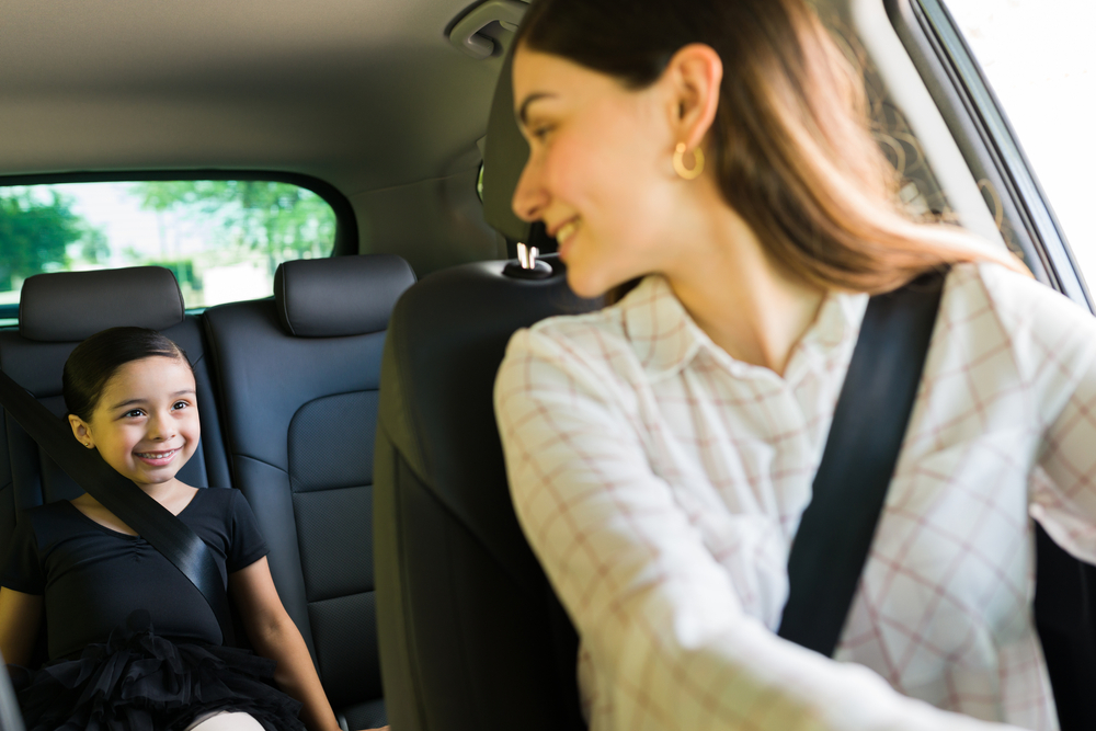 Parent driving child to school Franklin TN, INFINITI QX50 back seat child safety, Cool Springs school commute, back to school INFINITI family safety, INFINITI SUV school drop-off safety features, mom and daughter INFINITI driving