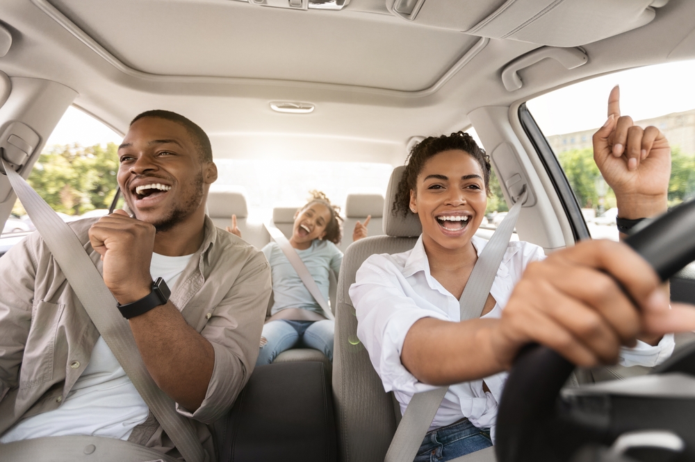 Happy family driving INFINITI after battery replacement, safe summer driving Cool Springs, new OEM INFINITI battery Franklin TN, reliable car battery for summer travel, enjoy road trips with battery testing, family vehicle electrical safety, Cool Springs INFINITI service satisfaction