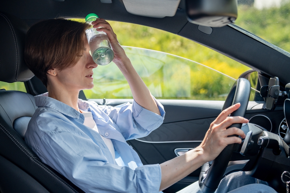 Driver sweating in luxury vehicle, INFINITI A/C failure symptoms, auto air conditioning not working Charlotte NC, driver overheating in Cornelius summer, INFINITI cabin not cooling, air conditioning repair needed Lake Norman, signs of A/C malfunction INFINITI SUV