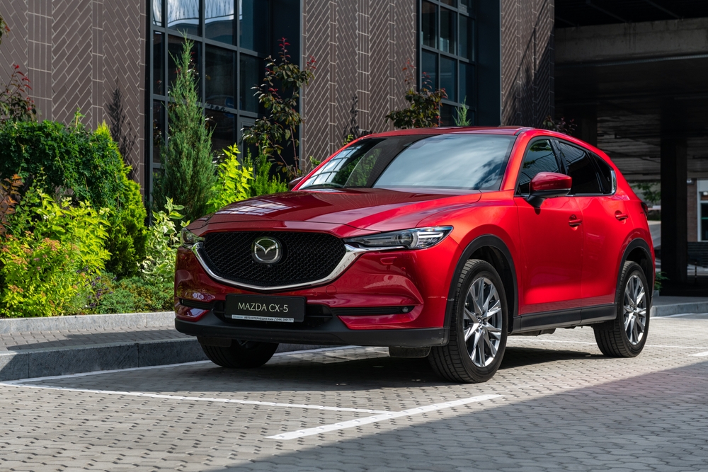 Mazda CX-5 parked outside, Daytona Mazda CX-5 service, Mazda SUV for school drop-off, red Mazda CX-5 safety features, Daytona Beach family SUV, Mazda tire maintenance Daytona, Mazda dealership Florida