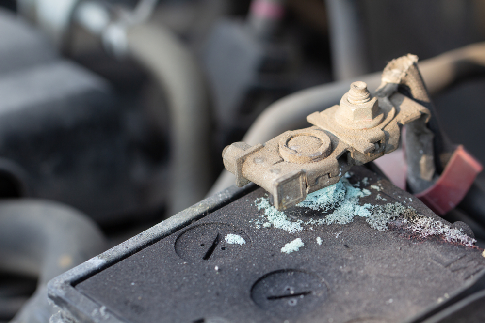 Corroded battery terminal on Nissan, signs of battery failure McDonough GA, battery corrosion Georgia climate, Nissan electrical issues heat damage, car battery maintenance McDonough Nissan Service Center