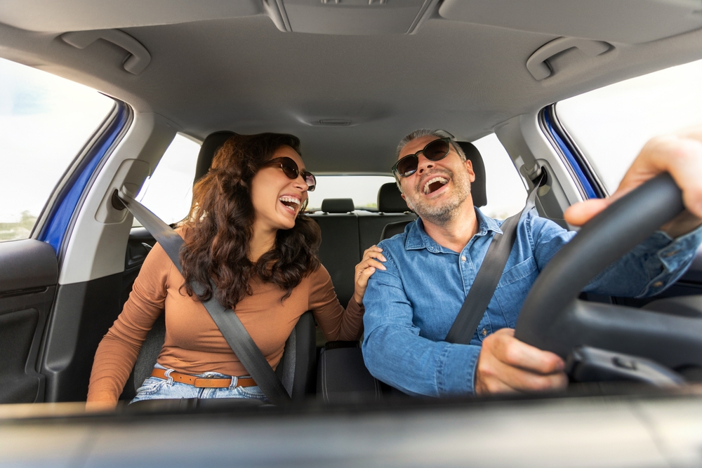Nissan AC service McDonough GA, cool comfortable summer driving in Georgia, happy drivers in cooled car, car air conditioning working Nissan, family road trip Georgia AC, Nissan cabin comfort, McDonough Nissan service center AC maintenance