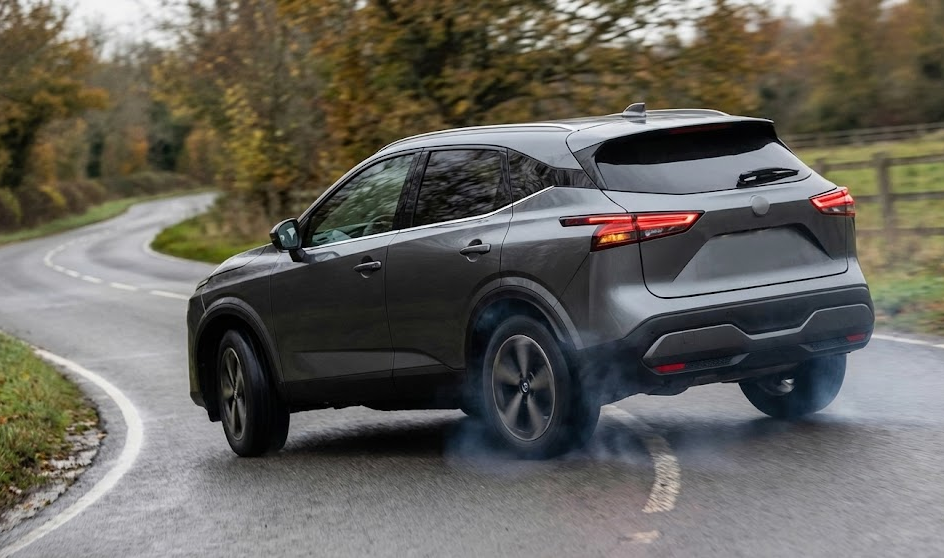 gray Nissan-style SUV braking hard on curvy country road, tires smoking during emergency stop, automatic emergency braking and traction control in action, fall leaves on rural Georgia roadway, deer avoidance maneuver near McDonough and Henry County GA, Nissan Safety Shield 360 real world performance, SUV stability control around sharp bend, wet pavement stopping distance example, Nissan crossover handling sudden obstacle on Highway 20, safe braking demonstration for Nissan service customers