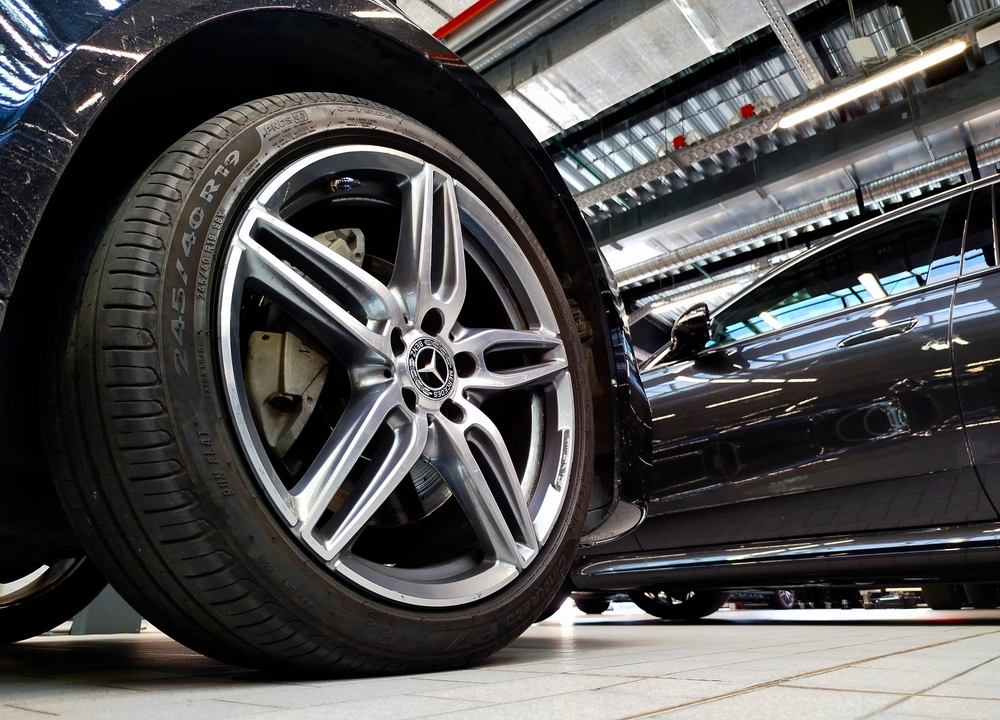 Mercedes-Benz AMG wheel close-up, tire sidewall inspection, summer tire safety Long Island Mercedes-Benz, tire alignment and wear analysis, Massapequa tire service Mercedes-Benz dealership, AMG rim tire safety check
