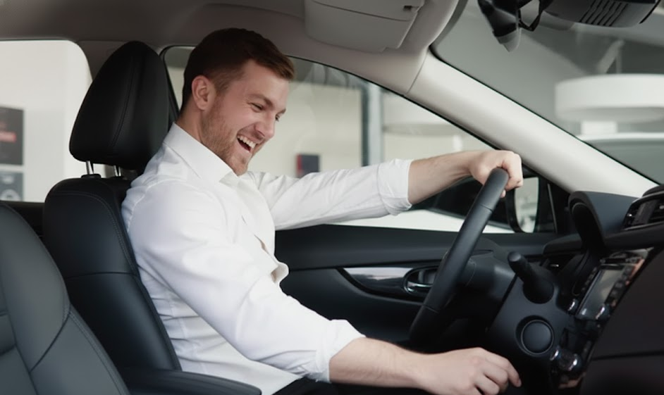 smiling driver inside modern luxury car, confident winter driving after installing Mercedes-Benz winter tires, happy customer at Mercedes-Benz of Massapequa Service Center, safe commute on Long Island roads, 4MATIC traction with proper cold weather tires, Massapequa NY winter tire specials, comfortable leather interior on Sunrise Highway, Nassau County luxury vehicle maintenance and safety, satisfied Mercedes-Benz owner ready for snow season