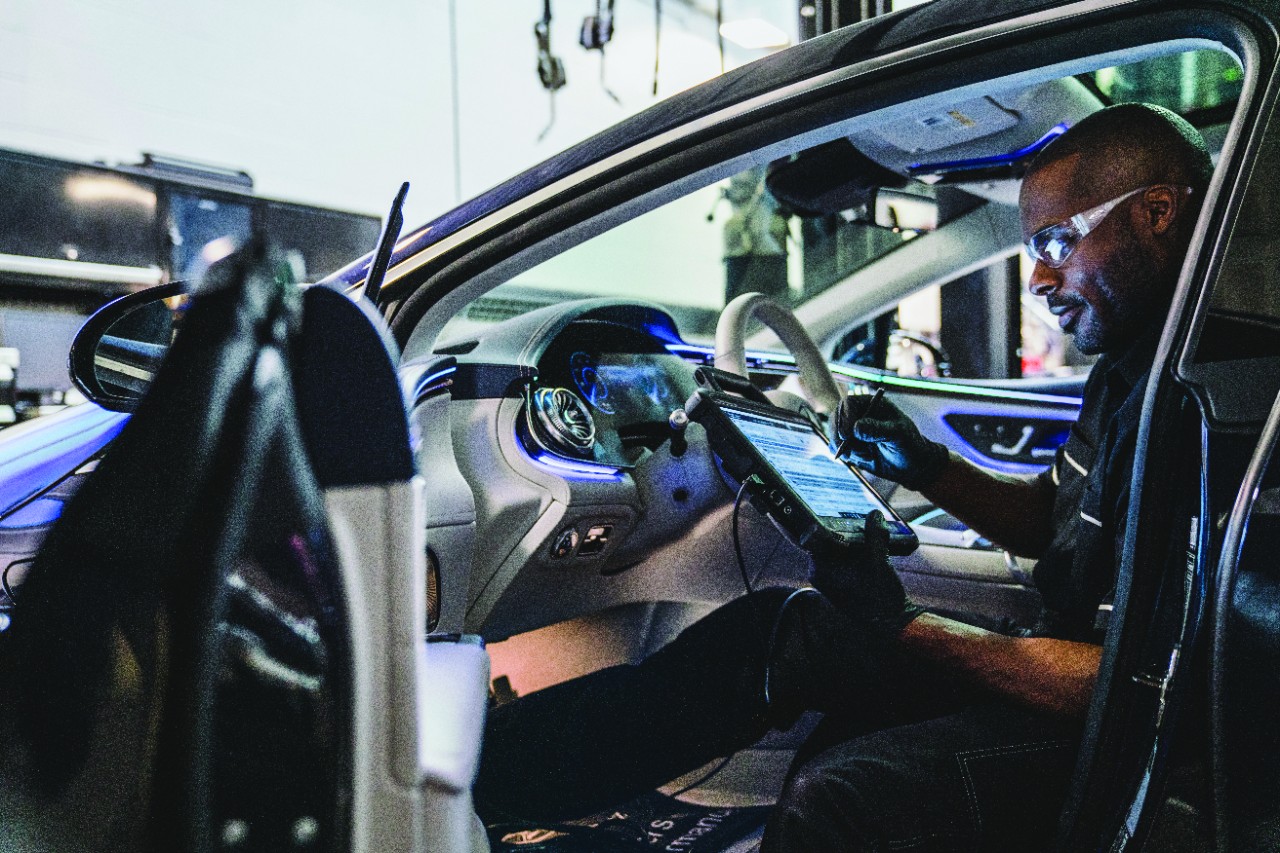 Mercedes-Benz technician running battery diagnostic inside luxury Mercedes interior, advanced electrical system testing Mercedes-Benz of Westminster, tablet-based battery health check Denver, AGM battery registration to Mercedes computer, high-tech Mercedes service bay Colorado, checking start stop system and voltage, expert Mercedes diagnostic service Westminster CO, winter readiness check for Mercedes electronics