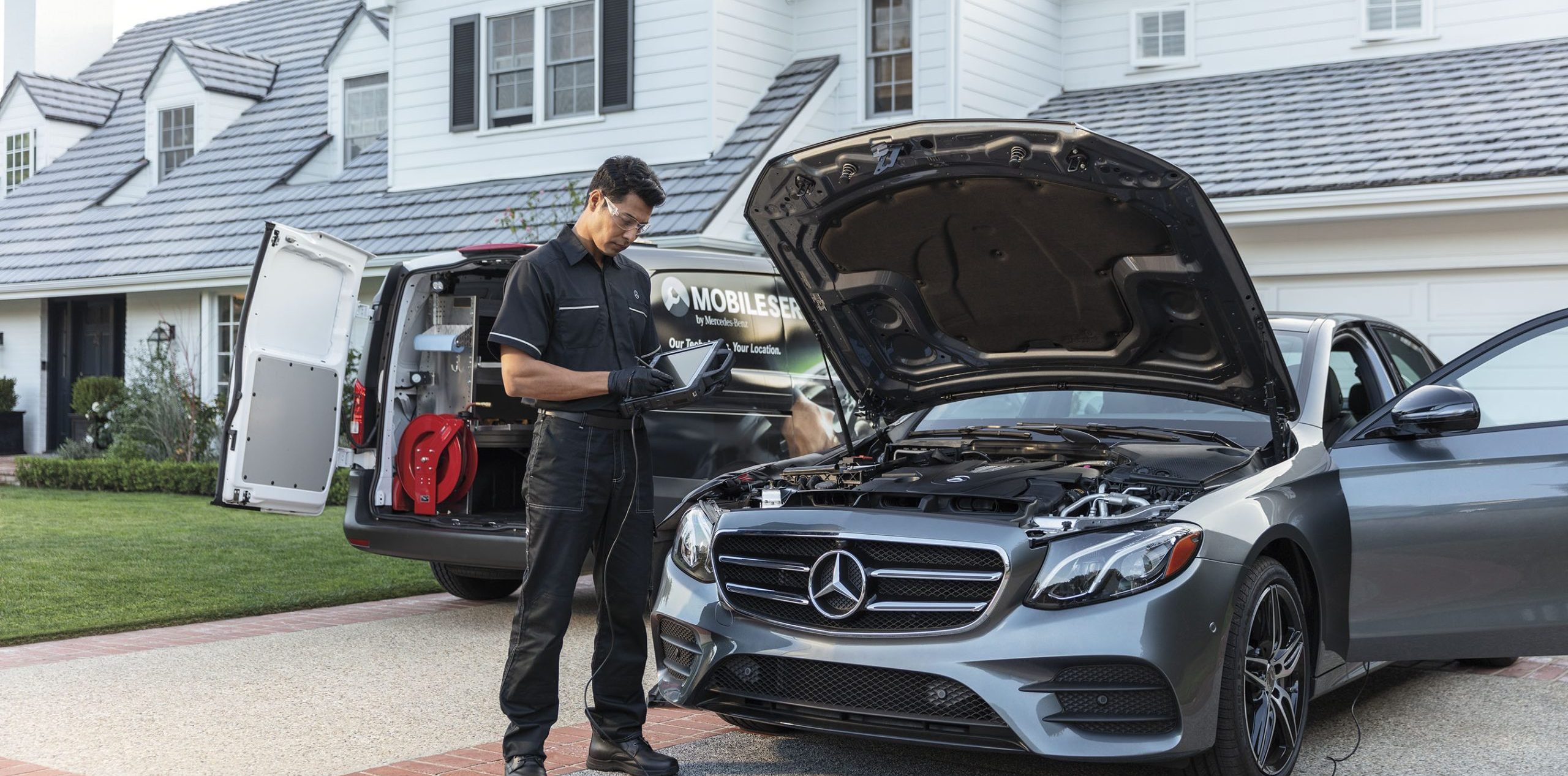 Mercedes-Benz Mobile Service technician performing driveway battery replacement, Mercedes-Benz of Westminster mobile battery service, at-home Mercedes repair Westminster CO, convenient Mercedes battery test at your location, mobile Mercedes mechanic Denver suburbs, winter prep mobile battery check Front Range, Mercedes-Benz service van visiting residential driveway, save time with mobile Mercedes maintenance