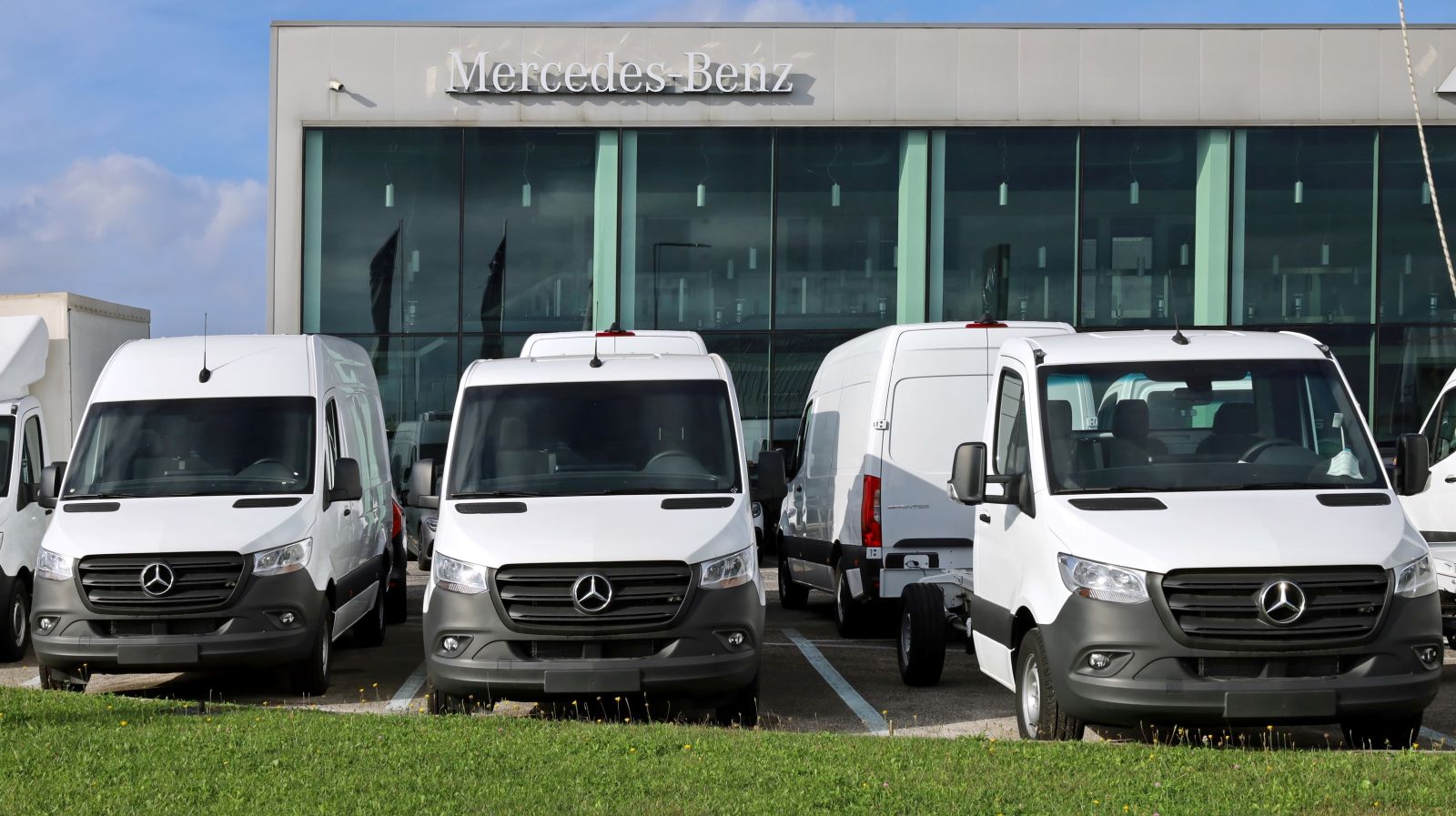 Row of Mercedes-Benz Sprinter cargo vans staged outside a commercial facility in the Denver metro area